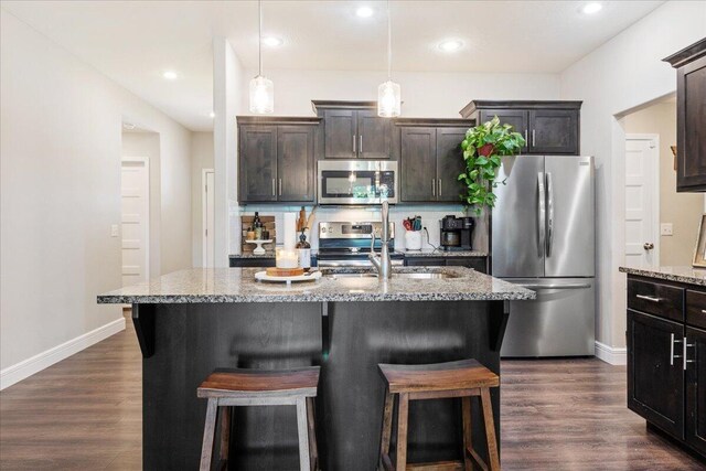 1651 N Penrose Ave, Nixa, MO 65714 - kitchen with stainless steel appliances, a kitchen breakfast bar, dark wood-type flooring, and recessed lighting