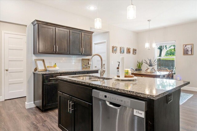 1651 N Penrose Ave, Nixa, MO 65714 - kitchen featuring stainless steel dishwasher, tasteful backsplash, dark wood-style flooring, light stone counters, and pendant lighting