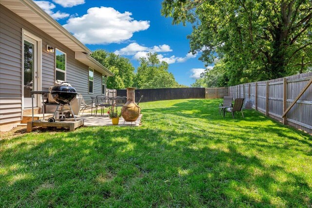 1651 N Penrose Ave, Nixa, MO 65714 - fenced backyard featuring a patio area