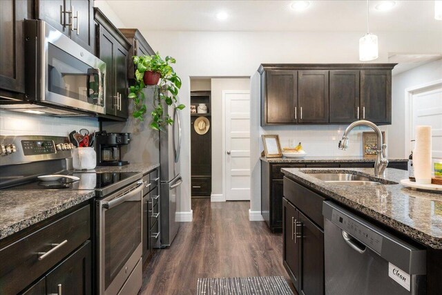 1651 N Penrose Ave, Nixa, MO 65714 - kitchen featuring stainless steel appliances, decorative backsplash, dark wood-style flooring, dark brown cabinetry, and recessed lighting