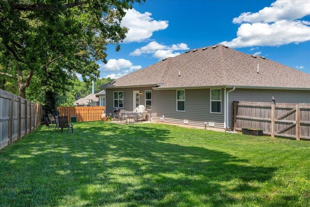 1651 N Penrose Ave, Nixa, MO 65714 - back of house with a fenced backyard, a shingled roof, and a patio