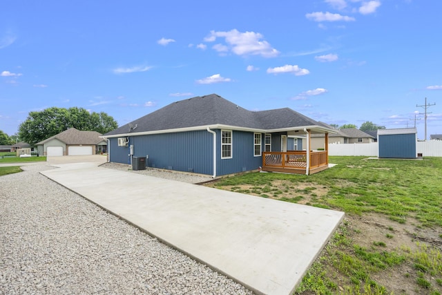 121 S Aspen St, Buffalo, MO 65622 - rear view of house with a shed, a detached garage, a deck, and a shingled roof