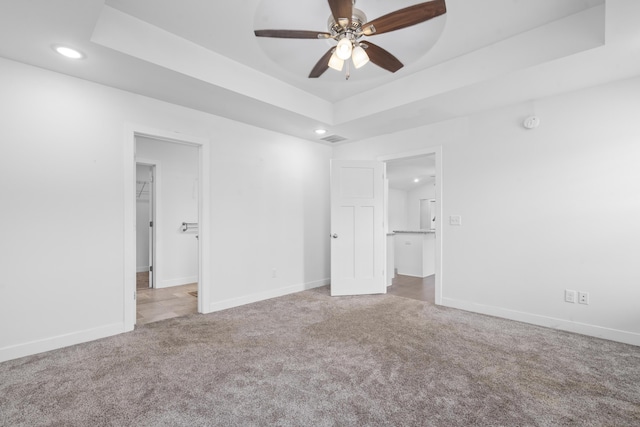 121 S Aspen St, Buffalo, MO 65622 - unfurnished bedroom with recessed lighting, carpet flooring, a raised ceiling, and a walk in closet