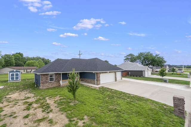 121 S Aspen St, Buffalo, MO 65622 - ranch-style house with an attached garage, driveway, a storage shed, a front lawn, and brick siding