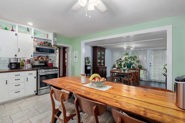 223 E Mill St, Republic, MO 65738 - kitchen featuring appliances with stainless steel finishes, white cabinets, dark countertops, a ceiling fan, and light tile patterned floors