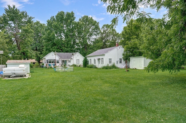 223 E Mill St, Republic, MO 65738 - view of grassy yard with a storage shed and view of wooded area