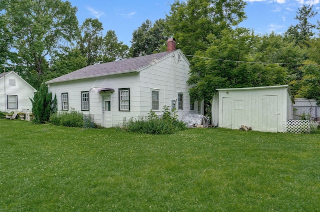 223 E Mill St, Republic, MO 65738 - view of front of house featuring a chimney, a front yard, and a storage unit