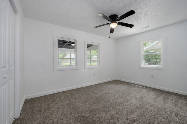 1317 S Willow Ave, Springfield, MO 65804 - empty room with healthy amount of natural light, carpet floors, a textured ceiling, and ceiling fan