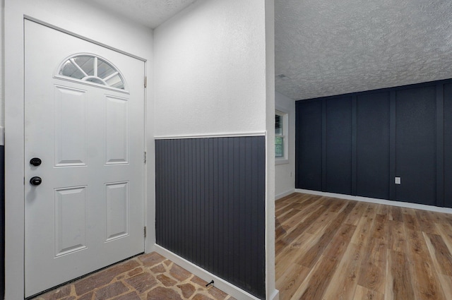 1317 S Willow Ave, Springfield, MO 65804 - foyer entrance with a textured ceiling, wood finished floors, and a decorative wall
