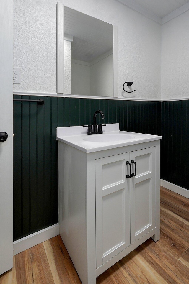 1317 S Willow Ave, Springfield, MO 65804 - bathroom featuring wainscoting, wood finished floors, crown molding, and vanity