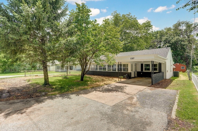 1317 S Willow Ave, Springfield, MO 65804 - single story home with concrete driveway, an attached carport, and roof with shingles