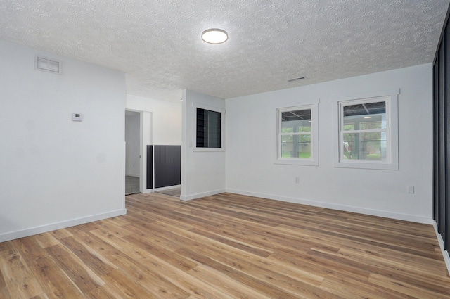 1317 S Willow Ave, Springfield, MO 65804 - spare room featuring light wood finished floors and a textured ceiling