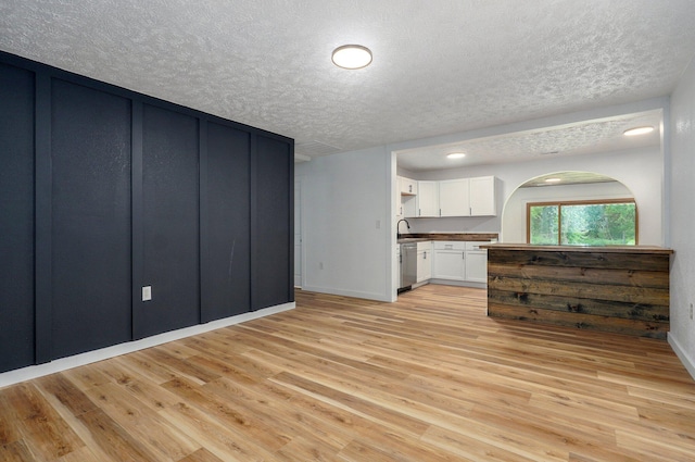 1317 S Willow Ave, Springfield, MO 65804 - kitchen with a textured ceiling, white cabinets, light wood-type flooring, and dishwasher