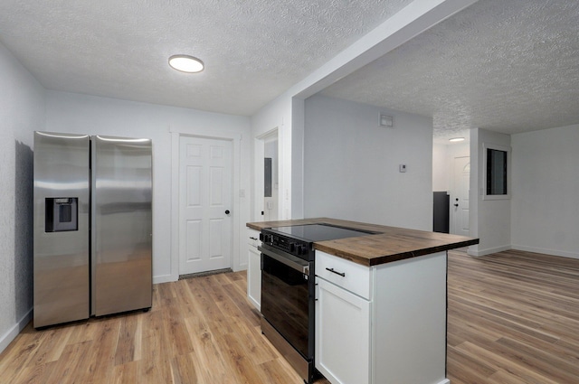1317 S Willow Ave, Springfield, MO 65804 - kitchen featuring stainless steel fridge with ice dispenser, butcher block counters, electric range, light wood-type flooring, and white cabinets