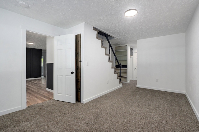 1317 S Willow Ave, Springfield, MO 65804 - basement featuring carpet, a textured ceiling, and stairway