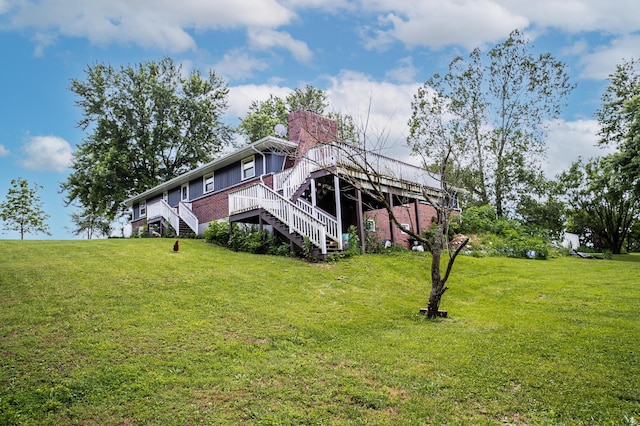 343 N Wood Ln, Fair Grove, MO 65648 - rear view of property with stairs, a yard, a wooden deck, and a chimney