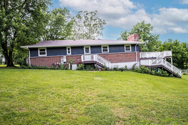 343 N Wood Ln, Fair Grove, MO 65648 - view of front facade featuring stairway, brick siding, and a chimney