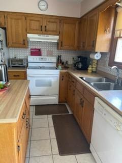 177 Marla Cir, Ozark, MO 65721 - kitchen featuring white appliances, under cabinet range hood, backsplash, light tile patterned flooring, and brown cabinetry