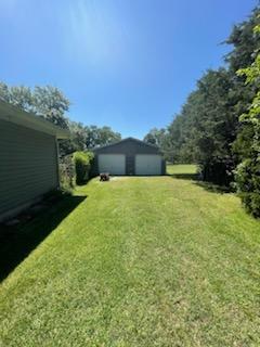177 Marla Cir, Ozark, MO 65721 - view of grassy yard featuring a garage and an outdoor structure