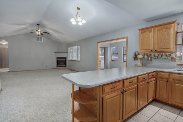 131 Forest Ln, Kimberling City, MO 65686 - kitchen featuring a ceiling fan, vaulted ceiling, light countertops, a glass covered fireplace, and open shelves