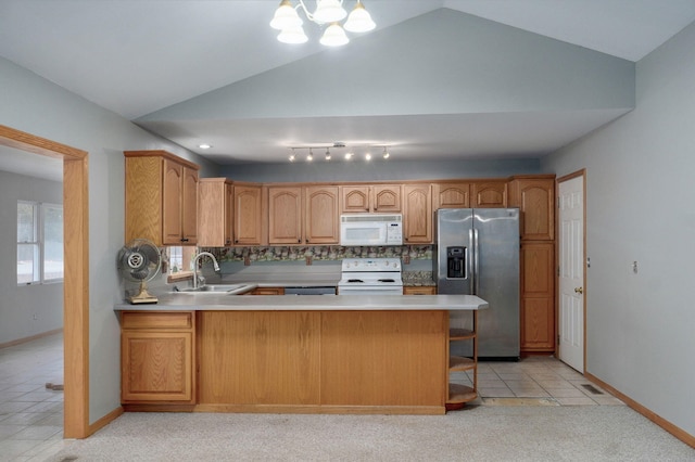 131 Forest Ln, Kimberling City, MO 65686 - kitchen featuring white appliances, vaulted ceiling, light countertops, a peninsula, and tasteful backsplash