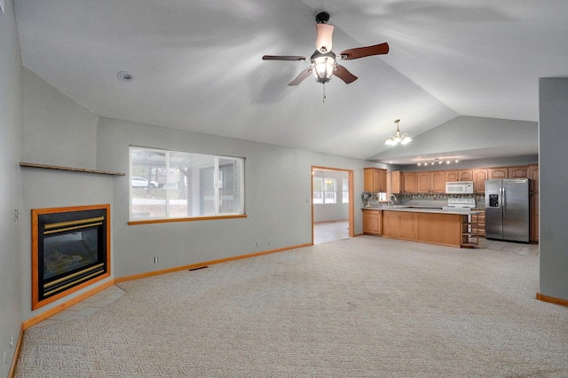 131 Forest Ln, Kimberling City, MO 65686 - unfurnished living room with vaulted ceiling, a fireplace with flush hearth, light carpet, ceiling fan, and a chandelier