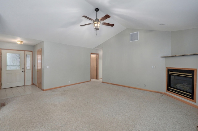 131 Forest Ln, Kimberling City, MO 65686 - unfurnished living room featuring light colored carpet, ceiling fan, lofted ceiling, and a glass covered fireplace