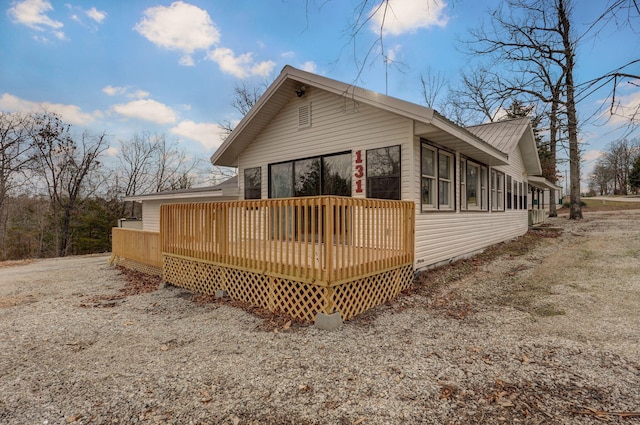 131 Forest Ln, Kimberling City, MO 65686 - rear view of property with a wooden deck and a metal roof