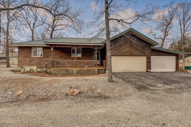 131 Forest Ln, Kimberling City, MO 65686 - view of front of property with a porch, a garage, a metal roof, and driveway