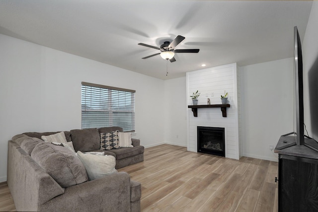 842 E Acacia Ln, Nixa, MO 65714 - living room with light wood-style floors, a ceiling fan, a large fireplace, and recessed lighting