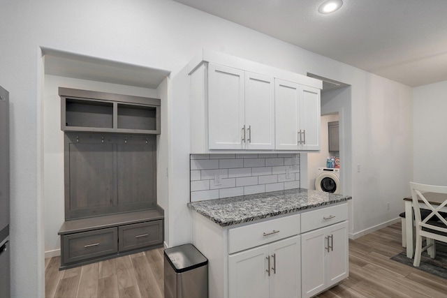 842 E Acacia Ln, Nixa, MO 65714 - kitchen featuring washer / dryer, light wood-style floors, light stone counters, tasteful backsplash, and recessed lighting