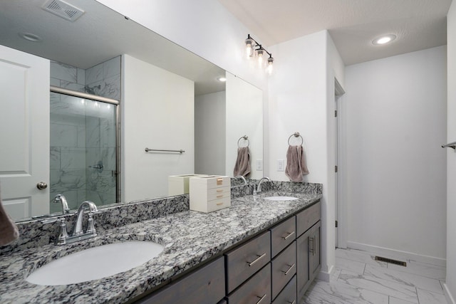842 E Acacia Ln, Nixa, MO 65714 - bathroom featuring double vanity, a marble finish shower, marble look tiles, and recessed lighting