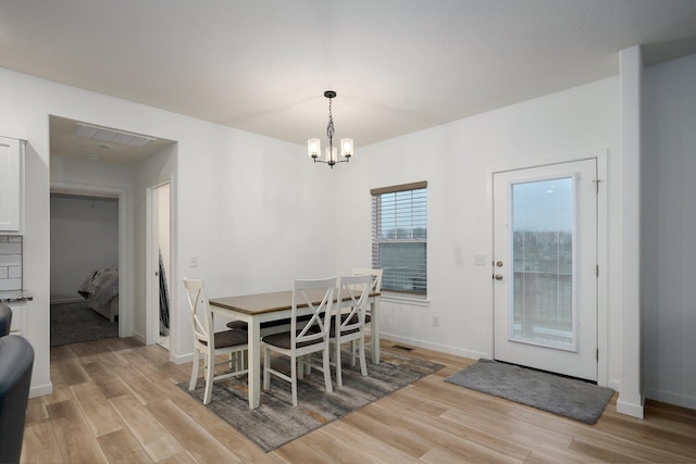 842 E Acacia Ln, Nixa, MO 65714 - dining area featuring light wood-type flooring and a chandelier