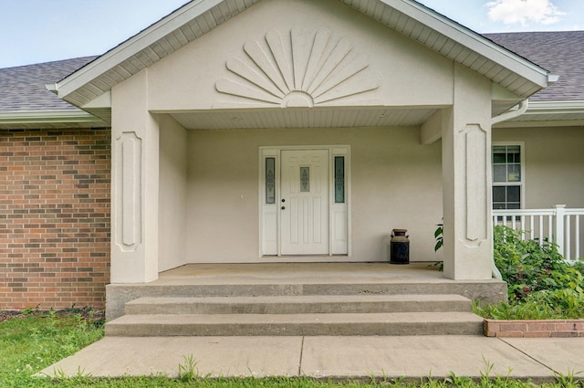 2240 Cherokee Ct, Nixa, MO 65714 - property entrance with roof with shingles, brick siding, and stucco siding