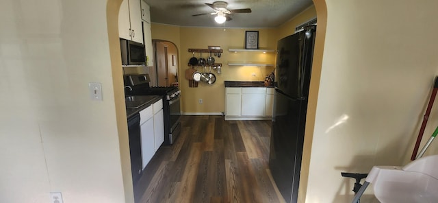 1972 N Colgate Ave, Springfield, MO 65802 - kitchen featuring arched walkways, appliances with stainless steel finishes, white cabinets, and dark countertops