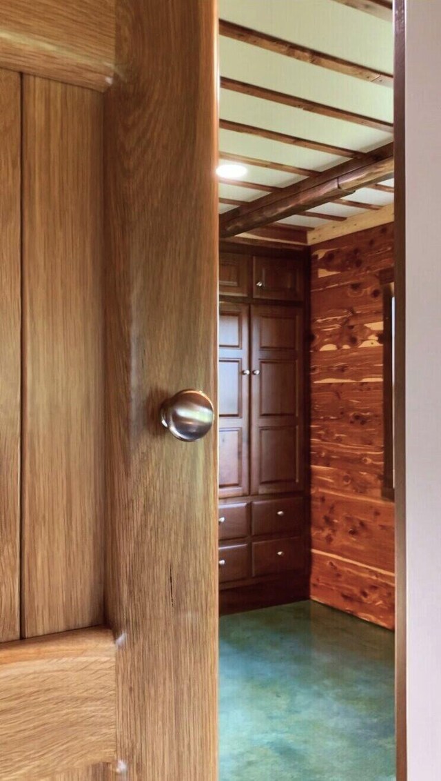 200 NE 90th Ln, Lamar, MO 64759 - hallway featuring wooden walls and beam ceiling