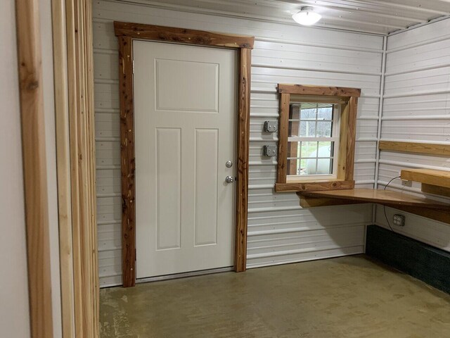 200 NE 90th Ln, Lamar, MO 64759 - entryway featuring wooden walls and concrete floors