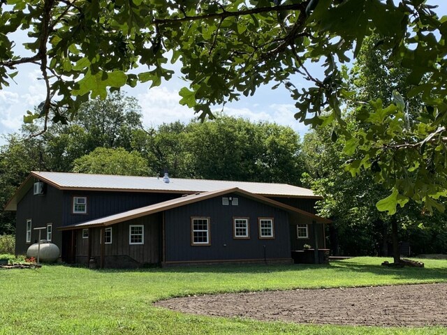 200 NE 90th Ln, Lamar, MO 64759 - view of side of property with a lawn and board and batten siding