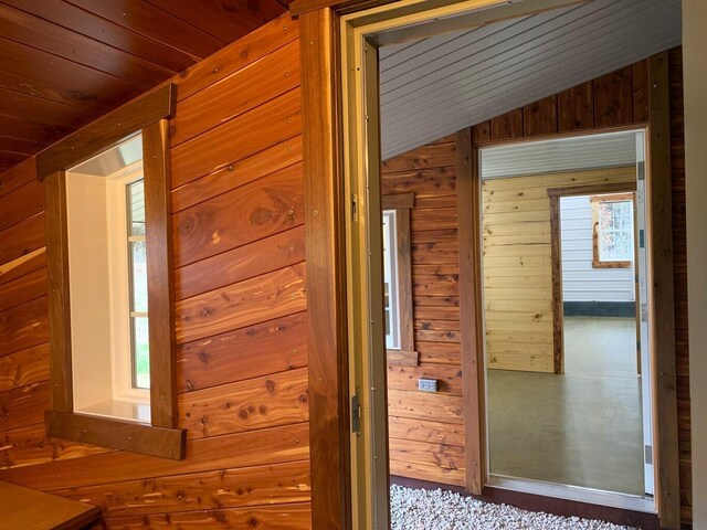 200 NE 90th Ln, Lamar, MO 64759 - hall featuring wooden walls, vaulted ceiling, and wood ceiling