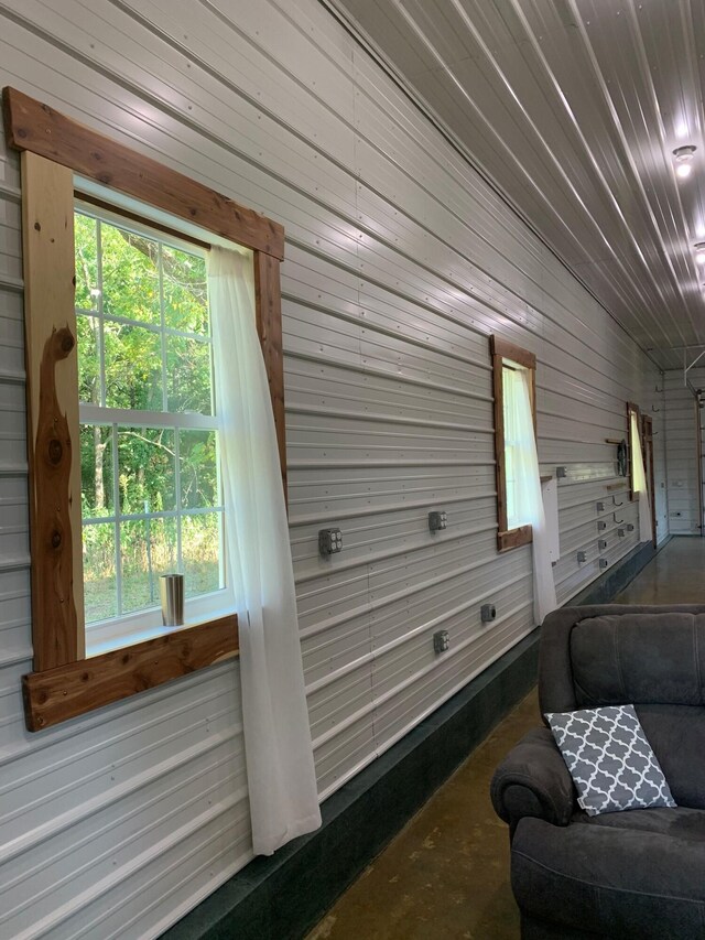 200 NE 90th Ln, Lamar, MO 64759 - sitting room with wooden walls, concrete floors, and healthy amount of natural light