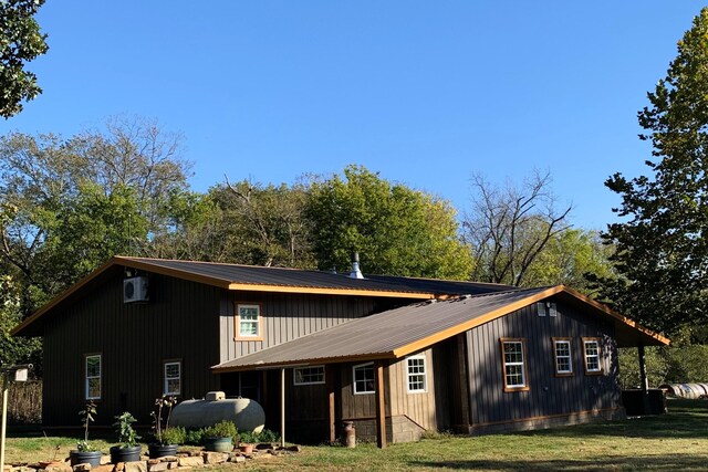 200 NE 90th Ln, Lamar, MO 64759 - view of side of property featuring a metal roof and a yard