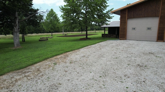 200 NE 90th Ln, Lamar, MO 64759 - view of grassy yard with gravel driveway and a garage