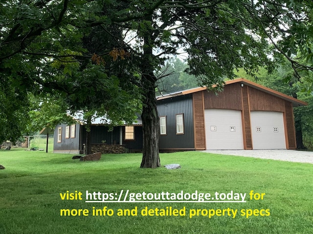 200 NE 90th Ln, Lamar, MO 64759 - view of front of home with a front lawn and a detached garage