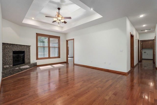 4520 English Ivy Ave, Springfield, MO 65804 - unfurnished living room featuring dark wood-style floors, a ceiling fan, a raised ceiling, a fireplace, and recessed lighting