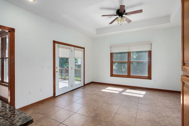 4520 English Ivy Ave, Springfield, MO 65804 - unfurnished room with light tile patterned flooring, ceiling fan, and a raised ceiling