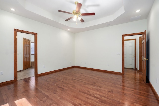 4520 English Ivy Ave, Springfield, MO 65804 - spare room with wood finished floors, a ceiling fan, a tray ceiling, and recessed lighting