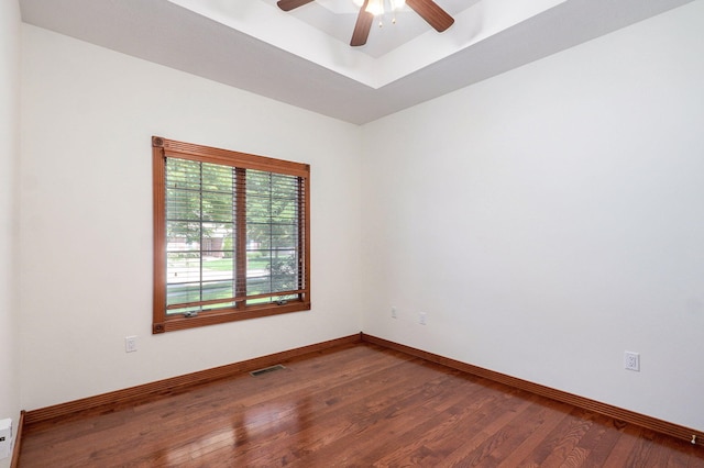 4520 English Ivy Ave, Springfield, MO 65804 - spare room with ceiling fan, wood finished floors, and a tray ceiling