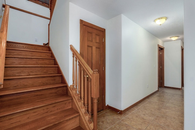 4520 English Ivy Ave, Springfield, MO 65804 - stairs featuring tile patterned flooring and baseboards