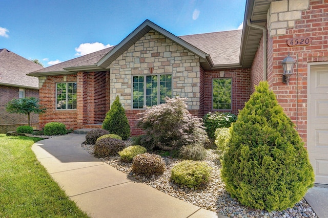 4520 English Ivy Ave, Springfield, MO 65804 - entrance to property featuring roof with shingles, brick siding, and stone siding