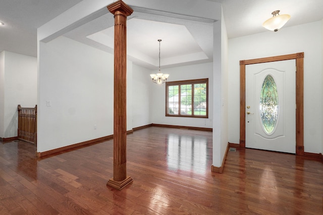 4520 English Ivy Ave, Springfield, MO 65804 - foyer featuring decorative columns, wood finished floors, a chandelier, and a raised ceiling
